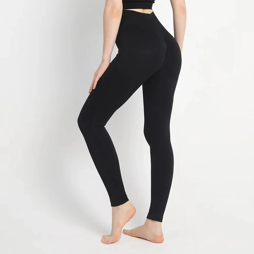 Black high-waisted leggings worn by a woman.