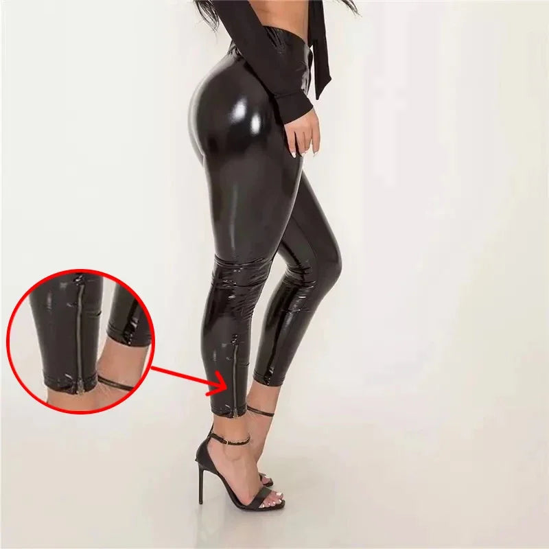 Shiny black latex or faux leather leggings with a zipper detail at the ankles.