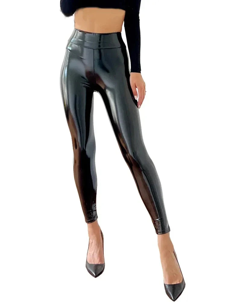 Shiny black faux leather leggings or pants worn with matching high heels.