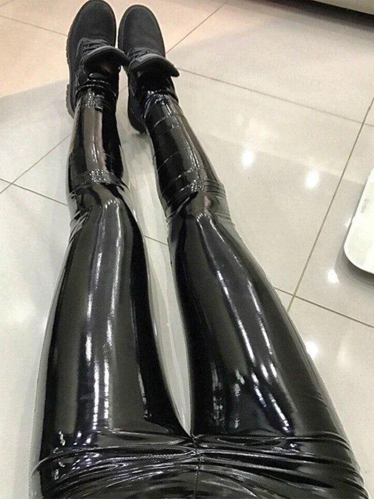 Pair of shiny black thigh-high boots or stockings made of latex or vinyl material.