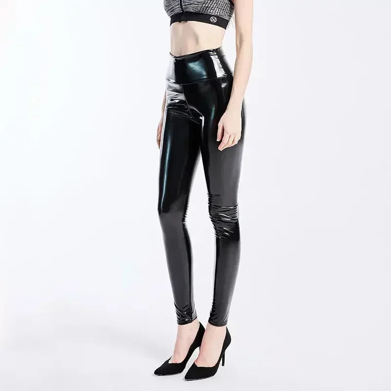 Shiny black latex or faux leather high-waisted leggings paired with black high heels.