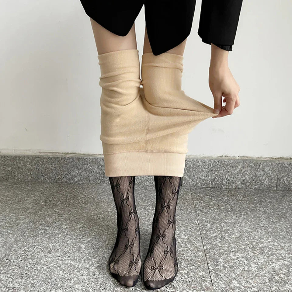 Beige skirt being pulled down to reveal patterned stockings underneath.