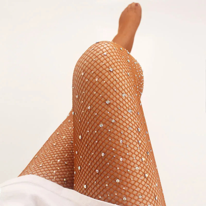 Sparkly fishnet stockings worn on a leg.