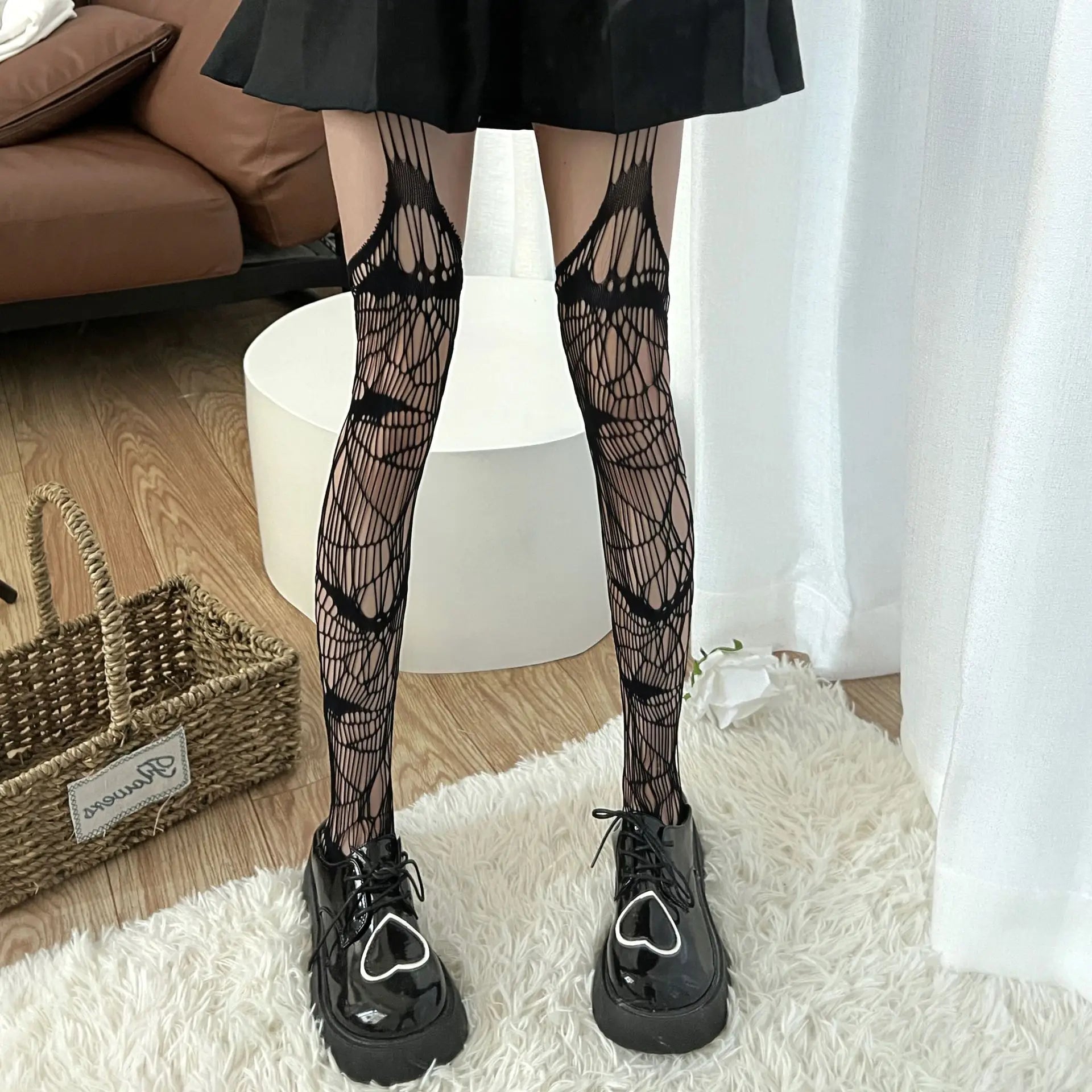 Pair of legs wearing intricate black patterned stockings and chunky platform shoes.