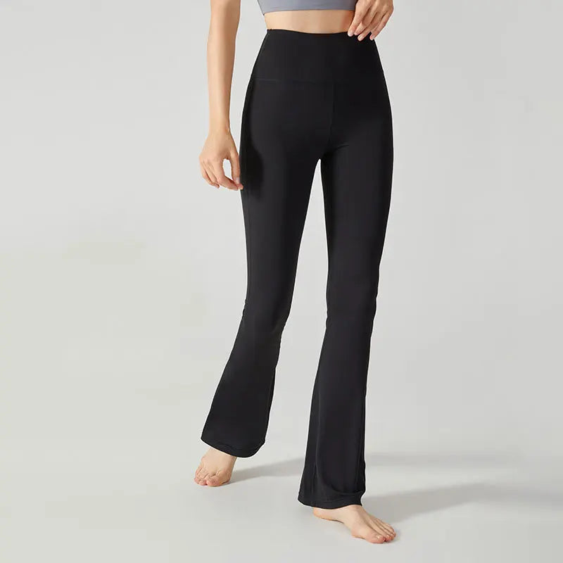 Black high-waisted flared yoga pants or leggings worn by a person.