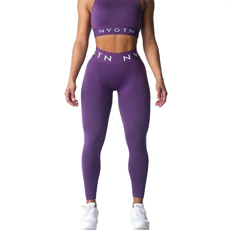 Purple workout set consisting of a crop top and high-waisted leggings with ’NVGTN’ branding.