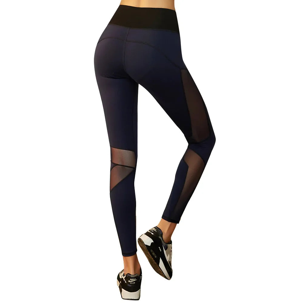 Black athletic leggings with sheer mesh panels and a wide waistband.