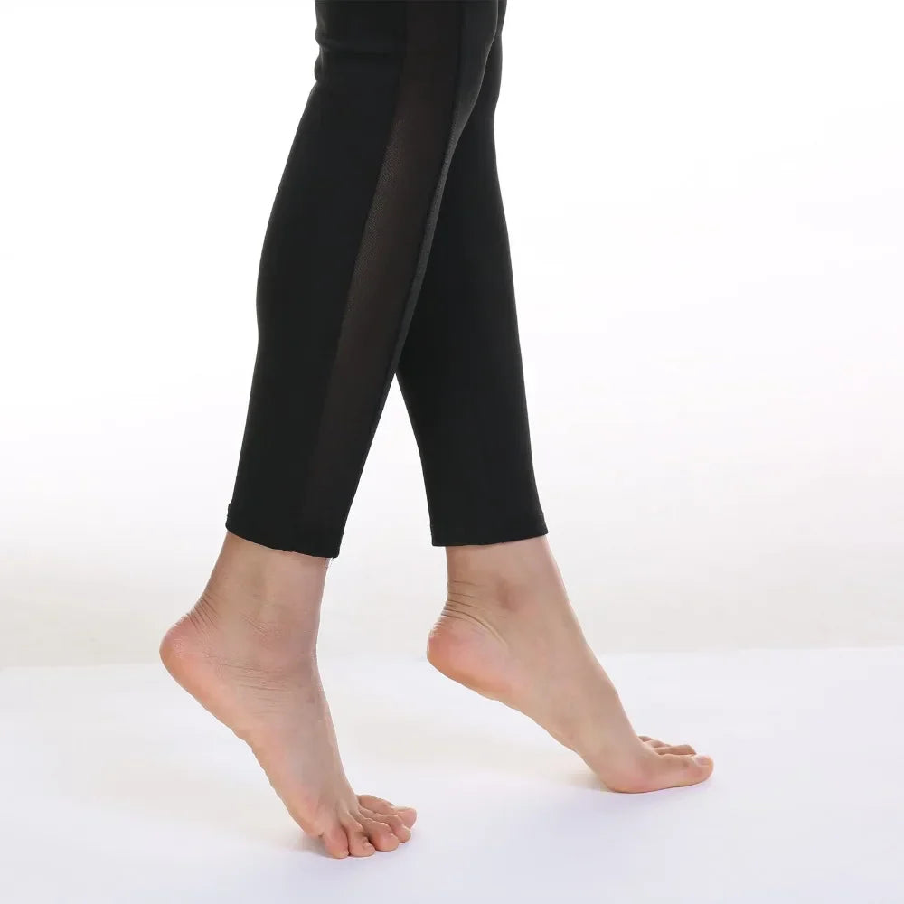 Pair of bare feet and lower legs wearing black leggings or tights.