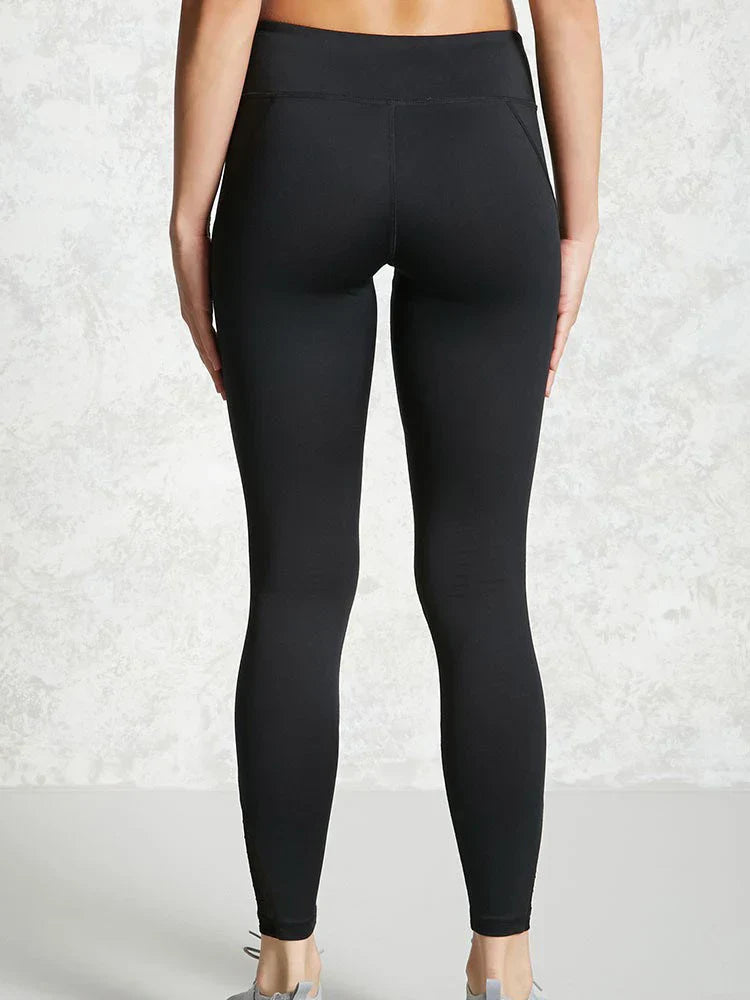 Black athletic leggings or yoga pants worn by a person.