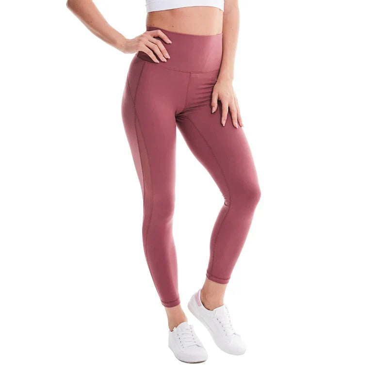 Pink high-waisted athletic leggings worn with white sneakers.