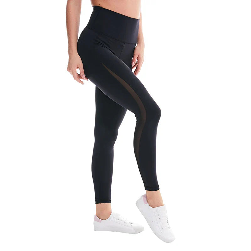 Black high-waisted athletic leggings with mesh side panels worn with white sneakers.