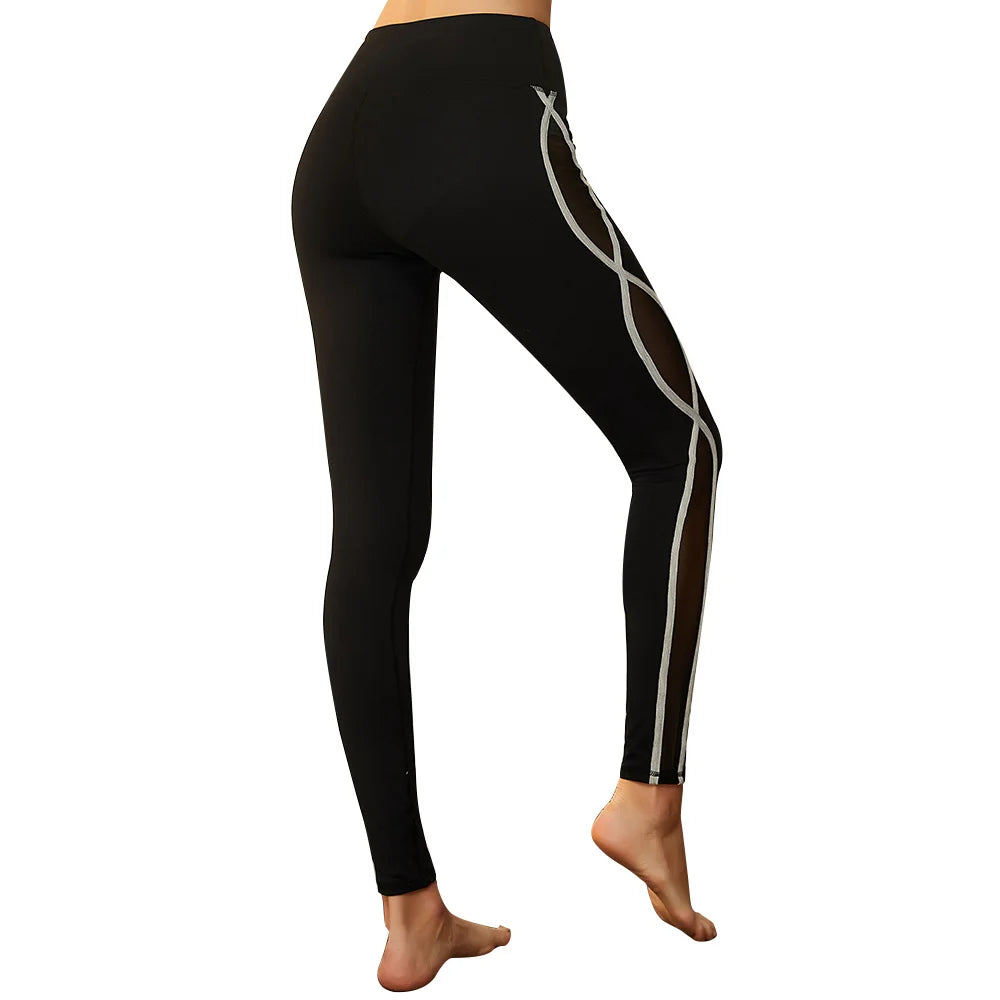 Black leggings with a silver swirling pattern on one leg.