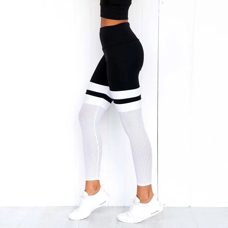 Black and white color-blocked athletic leggings with mesh detailing.