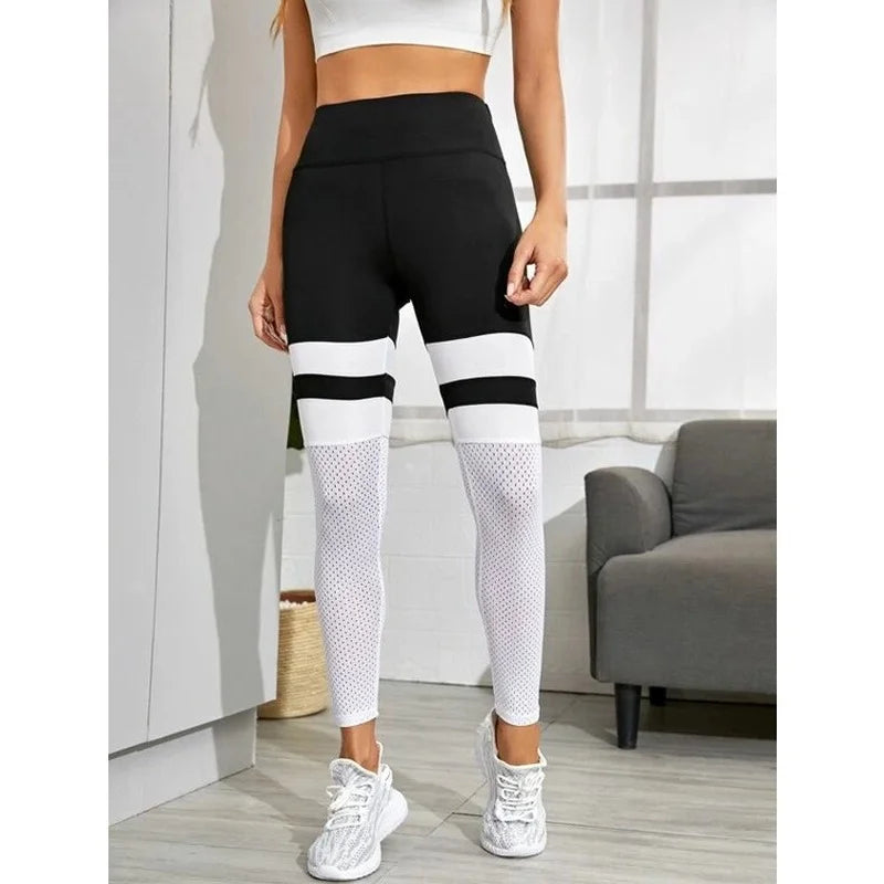 Black and white color-blocked leggings with mesh lower legs.