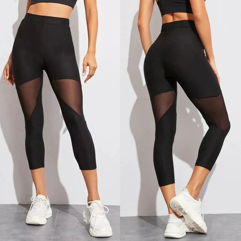 Black athletic leggings with sheer mesh panels on the thighs and calves.