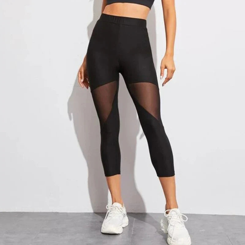 Black capri-length athletic leggings with sheer mesh panels on the thighs.