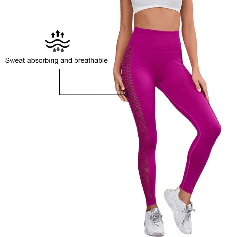 Bright magenta high-waisted athletic leggings with mesh side panels and a sweat-absorbing, breathable fabric.