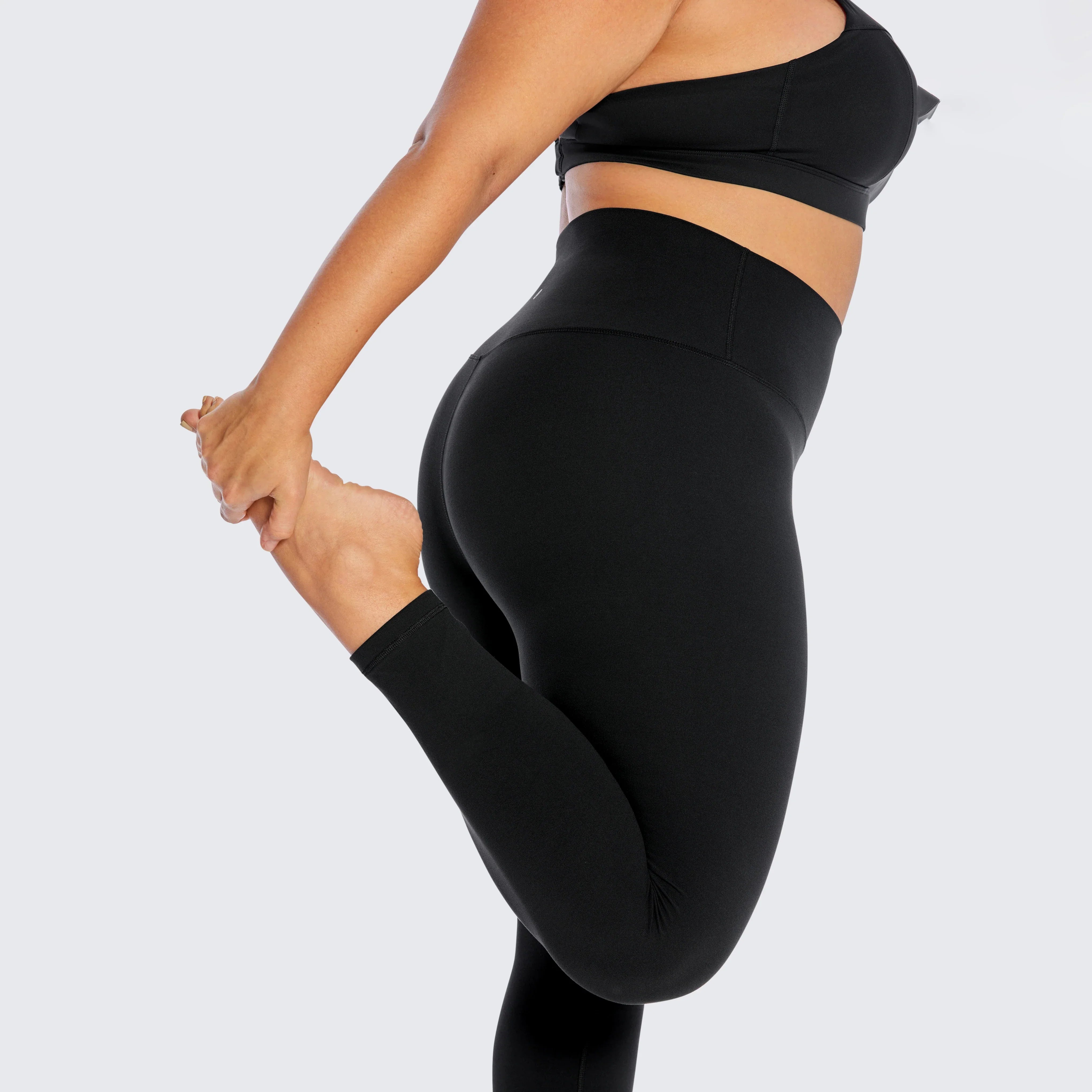 Black high-waisted athletic leggings paired with a matching sports bra.