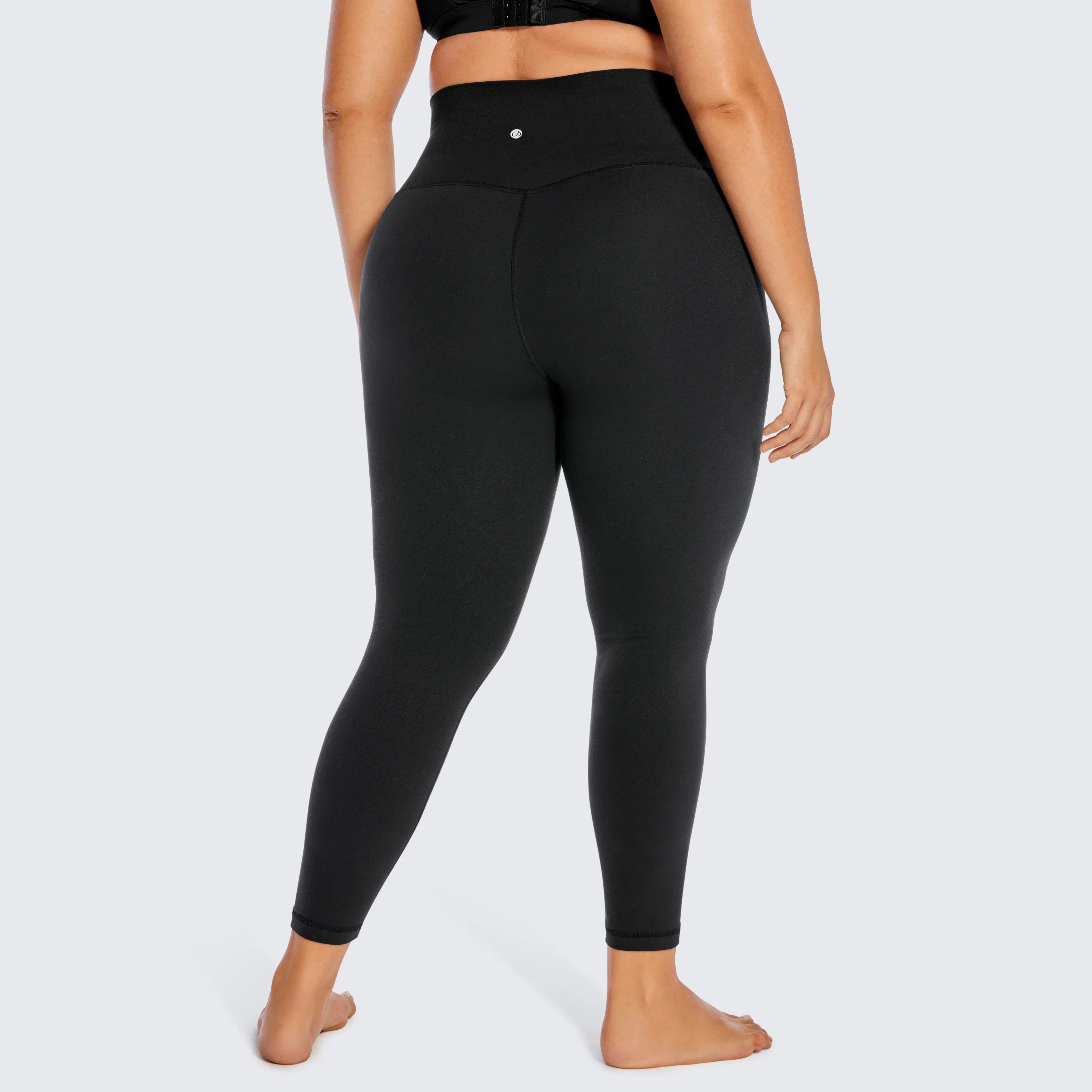 Black high-waisted athletic leggings worn by a person.