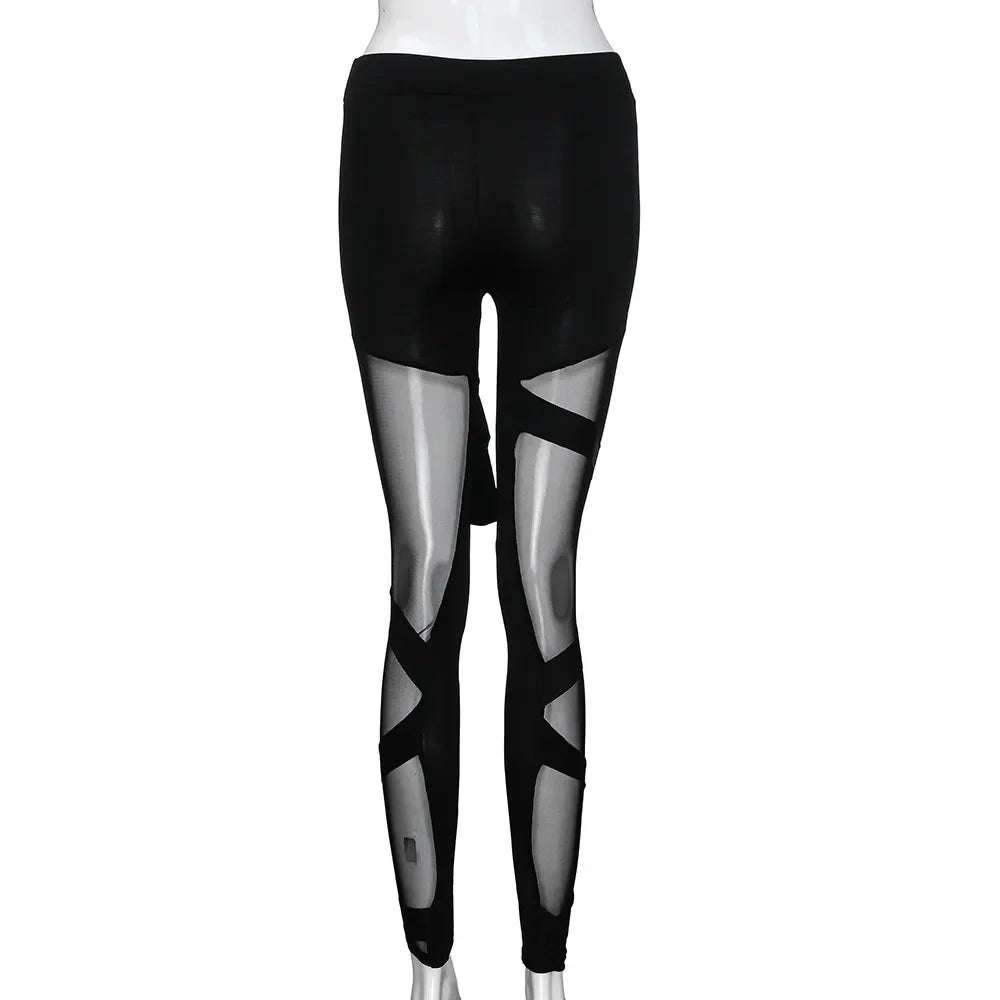 Black leggings with sheer mesh cutout panels on the legs.