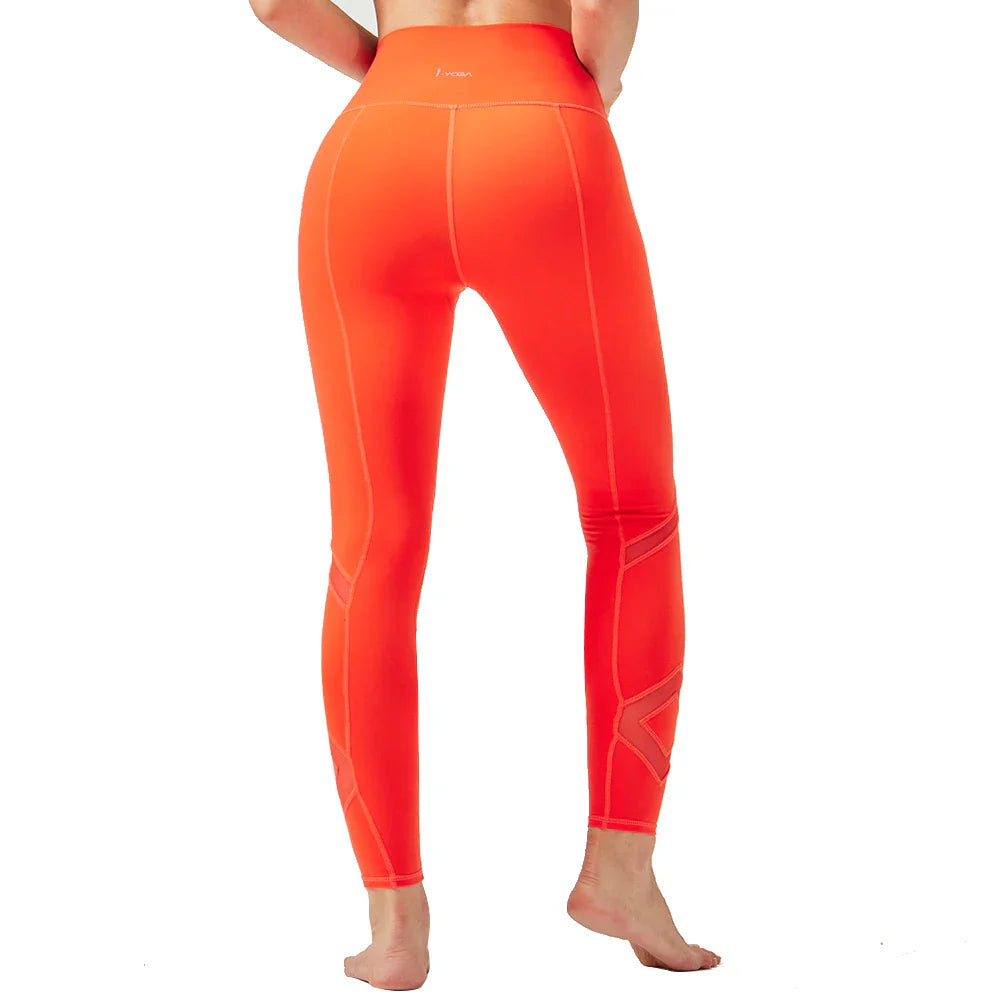 Bright orange athletic leggings with geometric pattern details on the lower leg.