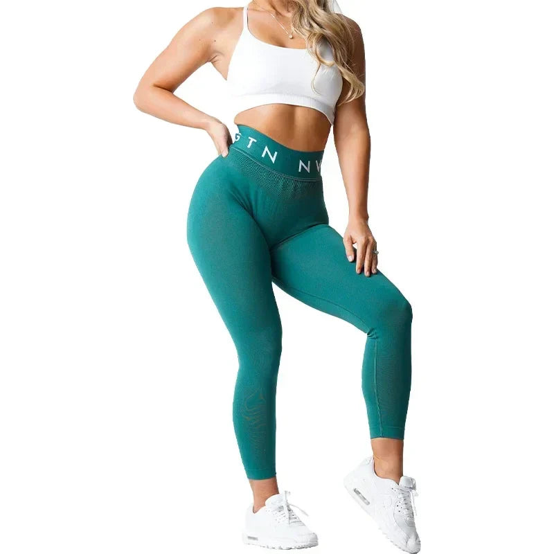 Teal high-waisted athletic leggings with a branded waistband.