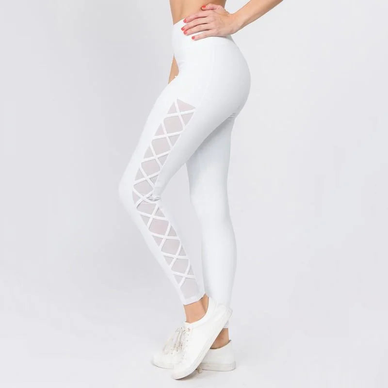 White leggings with a criss-cross mesh pattern on the side.