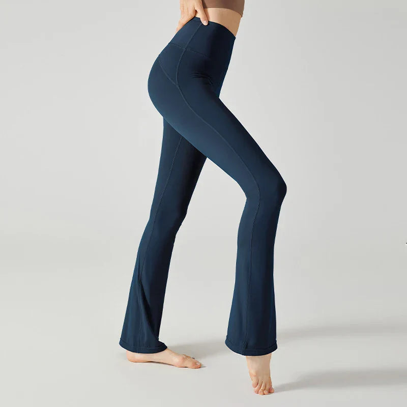 Navy blue flared yoga pants or leggings worn on a person’s lower body.