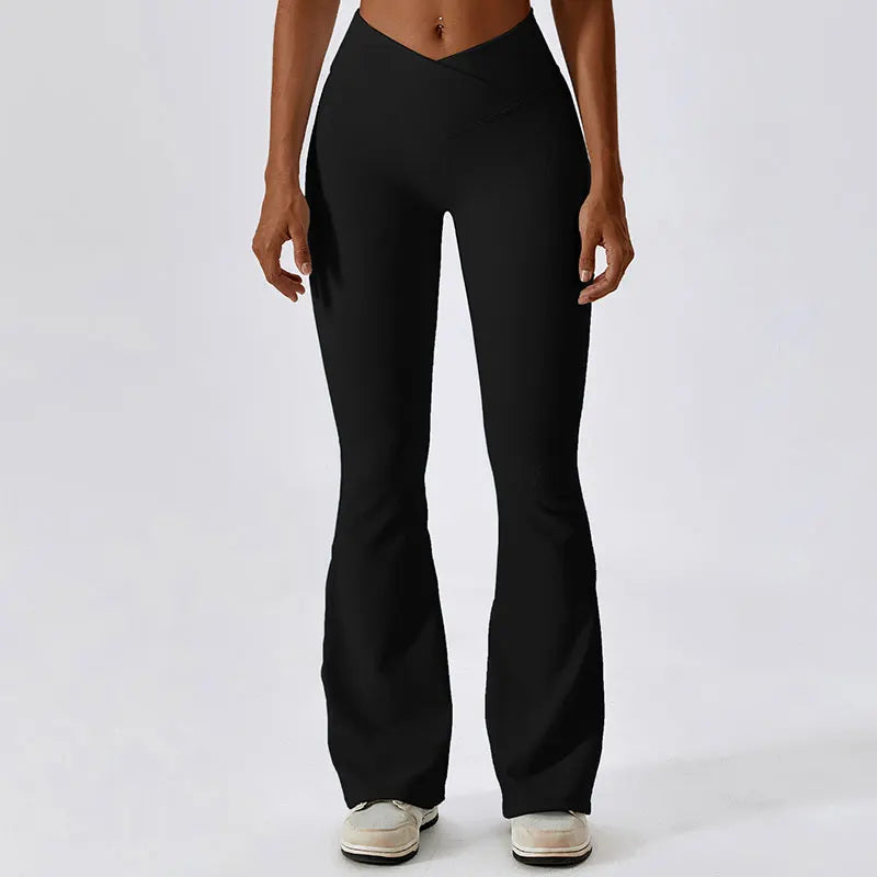 Black flared yoga pants or leggings worn by a person with a fit midriff visible.