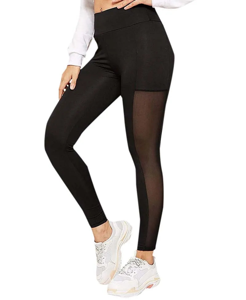 Black leggings with a sheer mesh panel on one leg, paired with white sneakers.